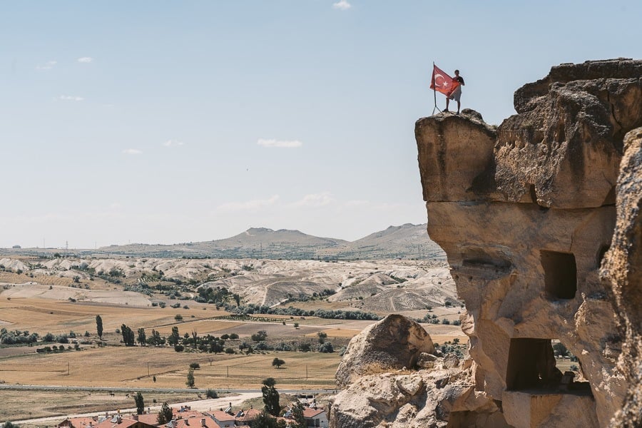 a person standing on top of a rock formation.