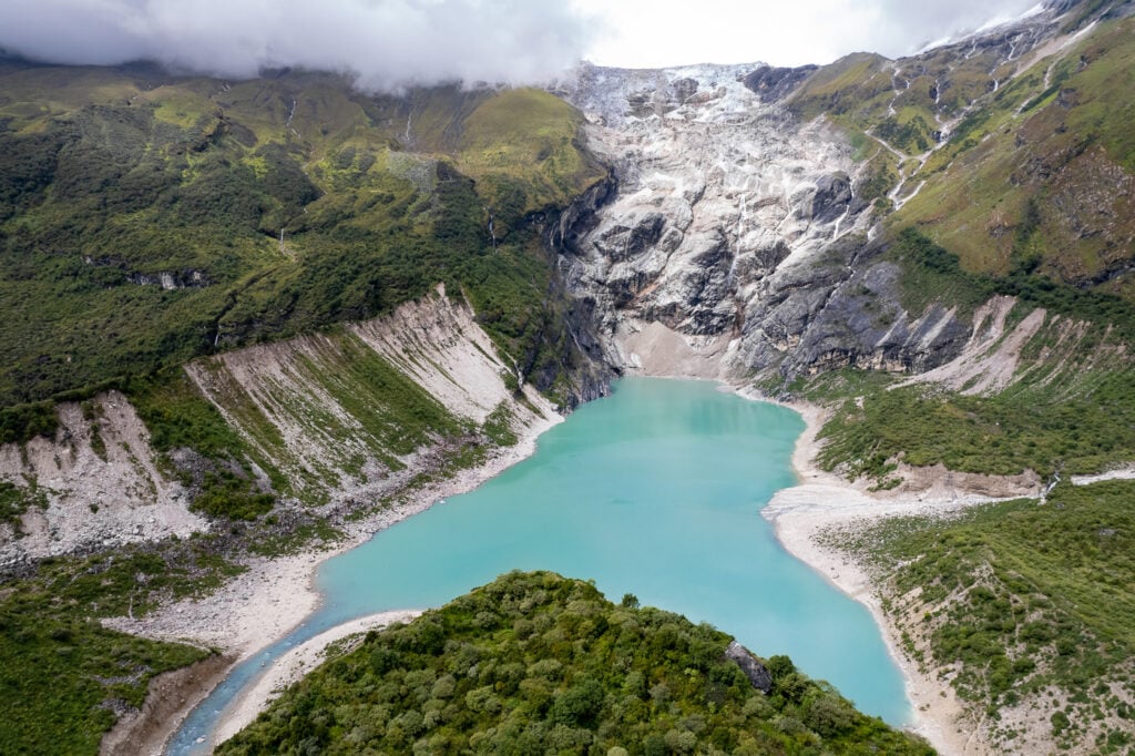 a blue lake surrounded by mountains and trees