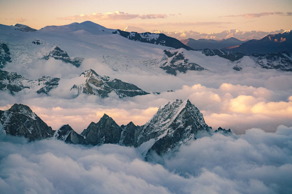 a view of a mountain range from above the clouds