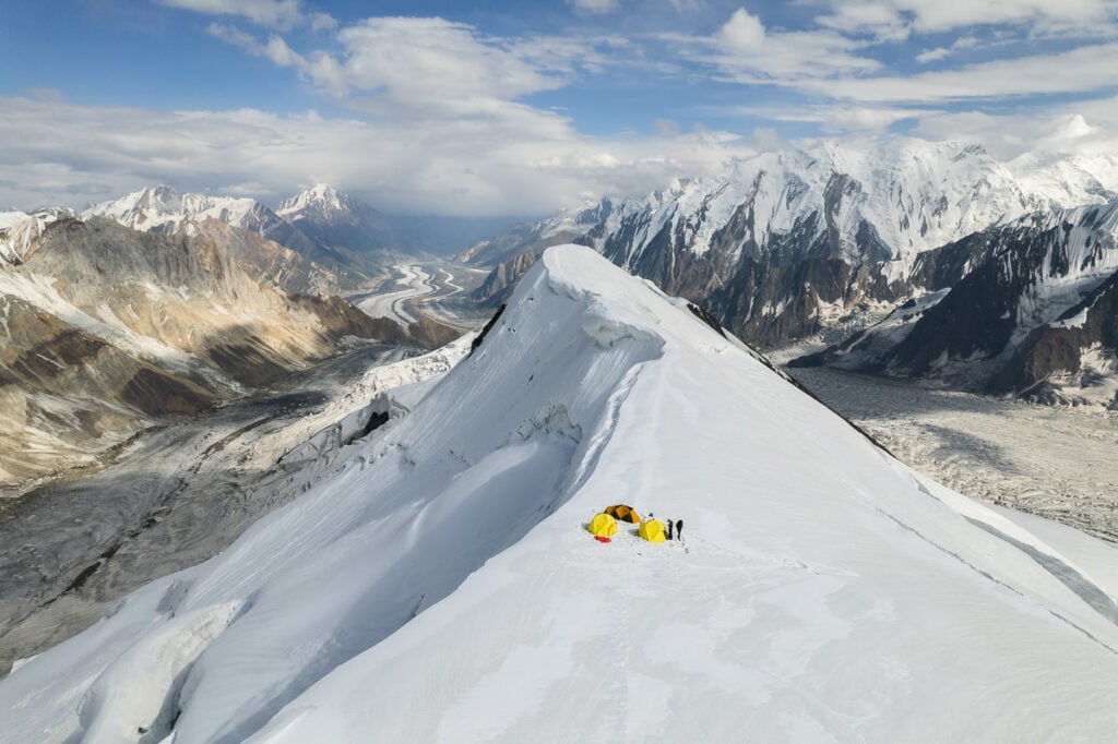 a person standing on top of a snow covered mountain