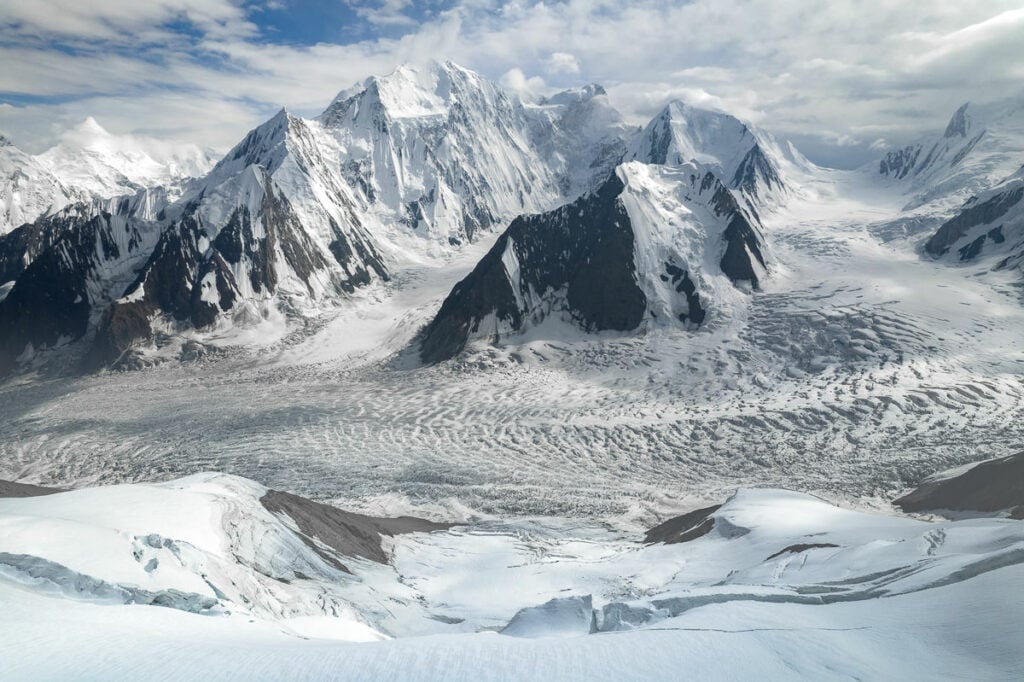 a view of a snowy mountain range from a plane