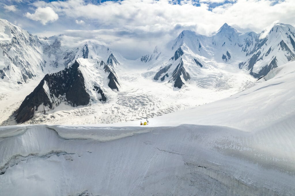 a group of people riding skis on top of a snow covered slope