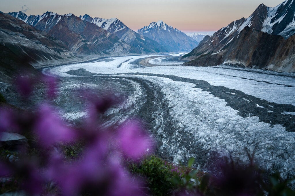 a river running through a valley surrounded by mountains