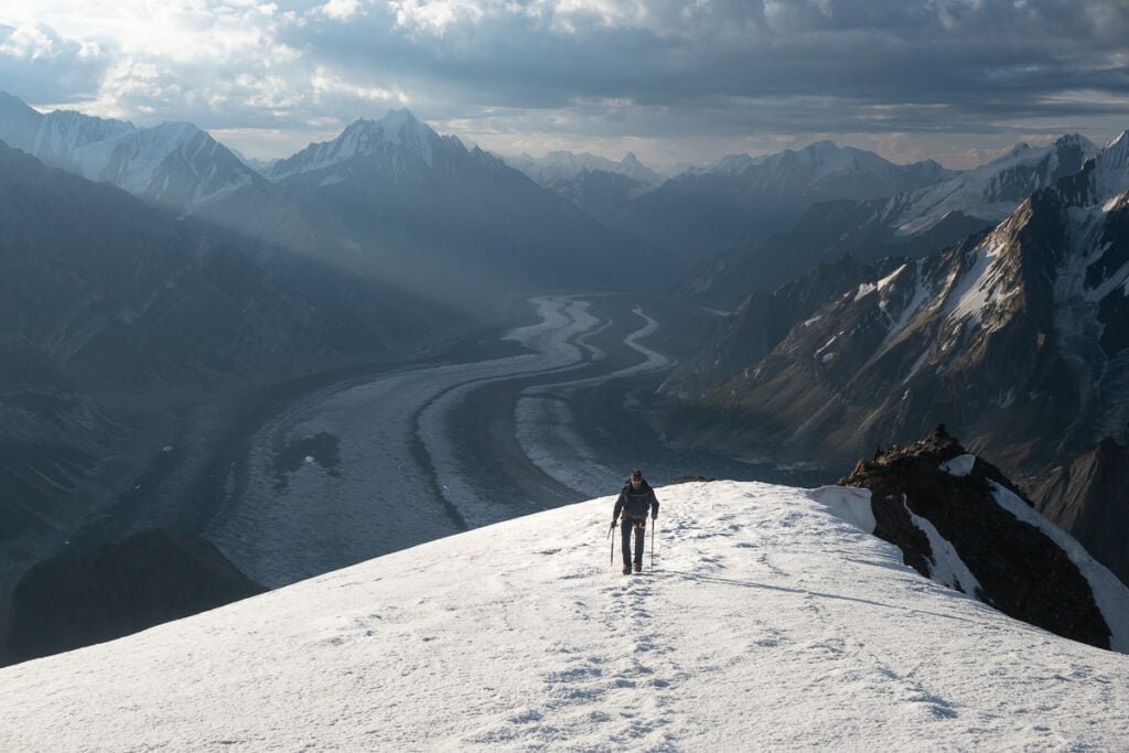 a person standing on top of a snow covered mountain