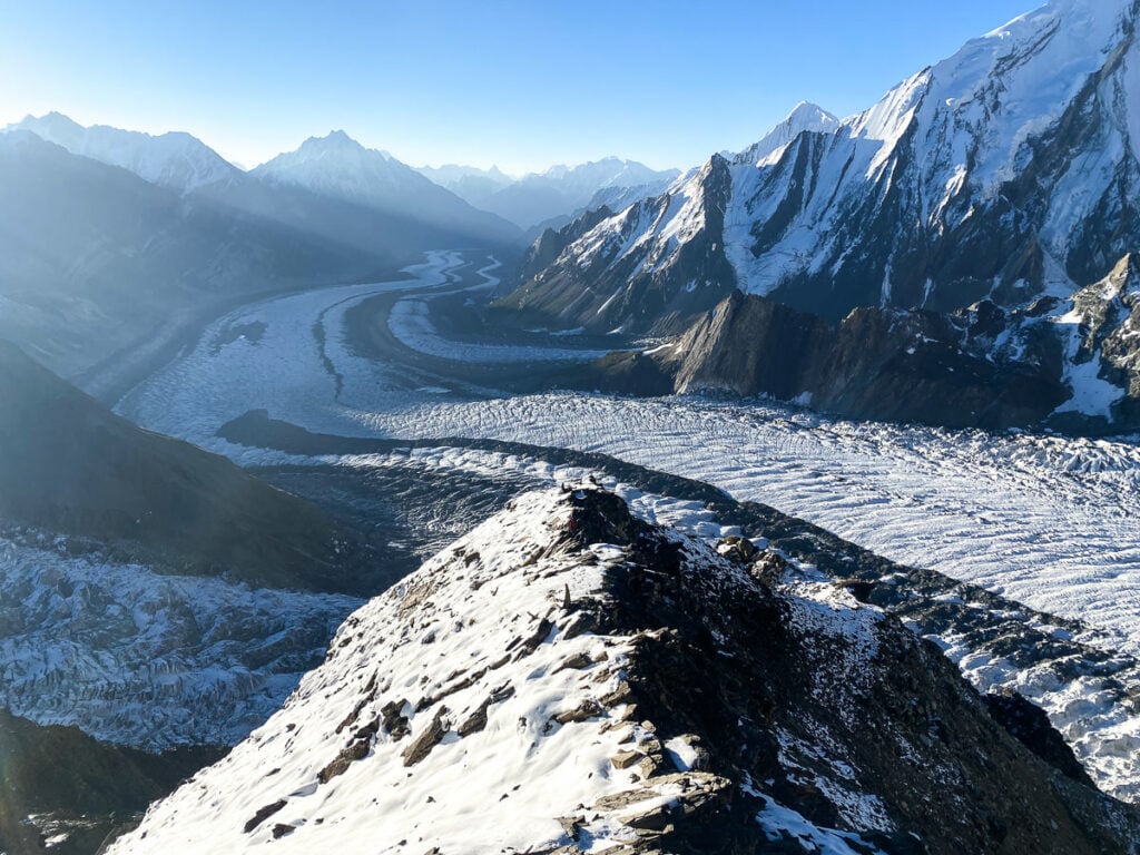 a snow covered mountain with a river running through it