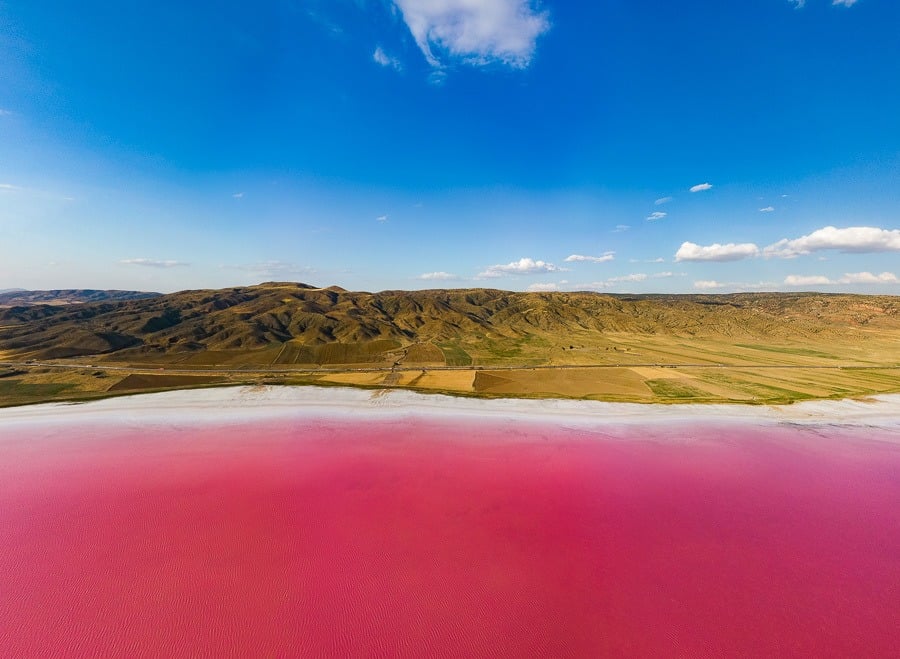 a large body of water surrounded by hills.
