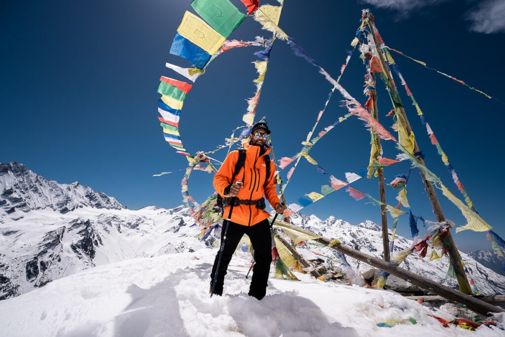 a man standing on top of a snow covered mountain