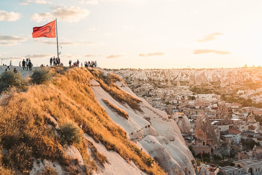 a group of people standing on top of a hill.
