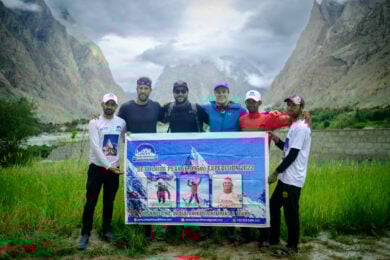 a group of men standing next to each other holding a sign